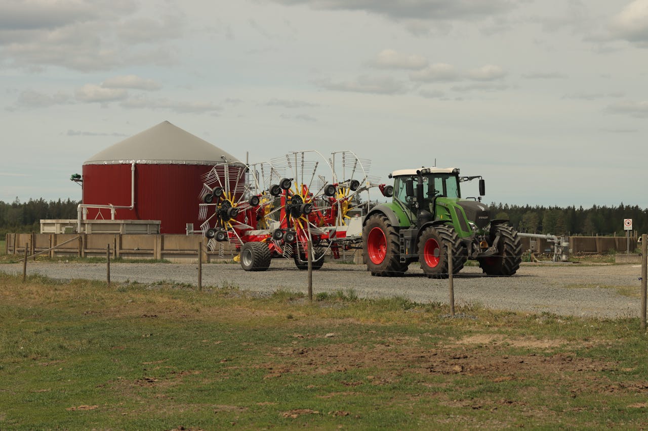 digital-01 A modern tractor with rakes at a farm in Jönköping, Sweden captures the essence of contemporary agriculture.