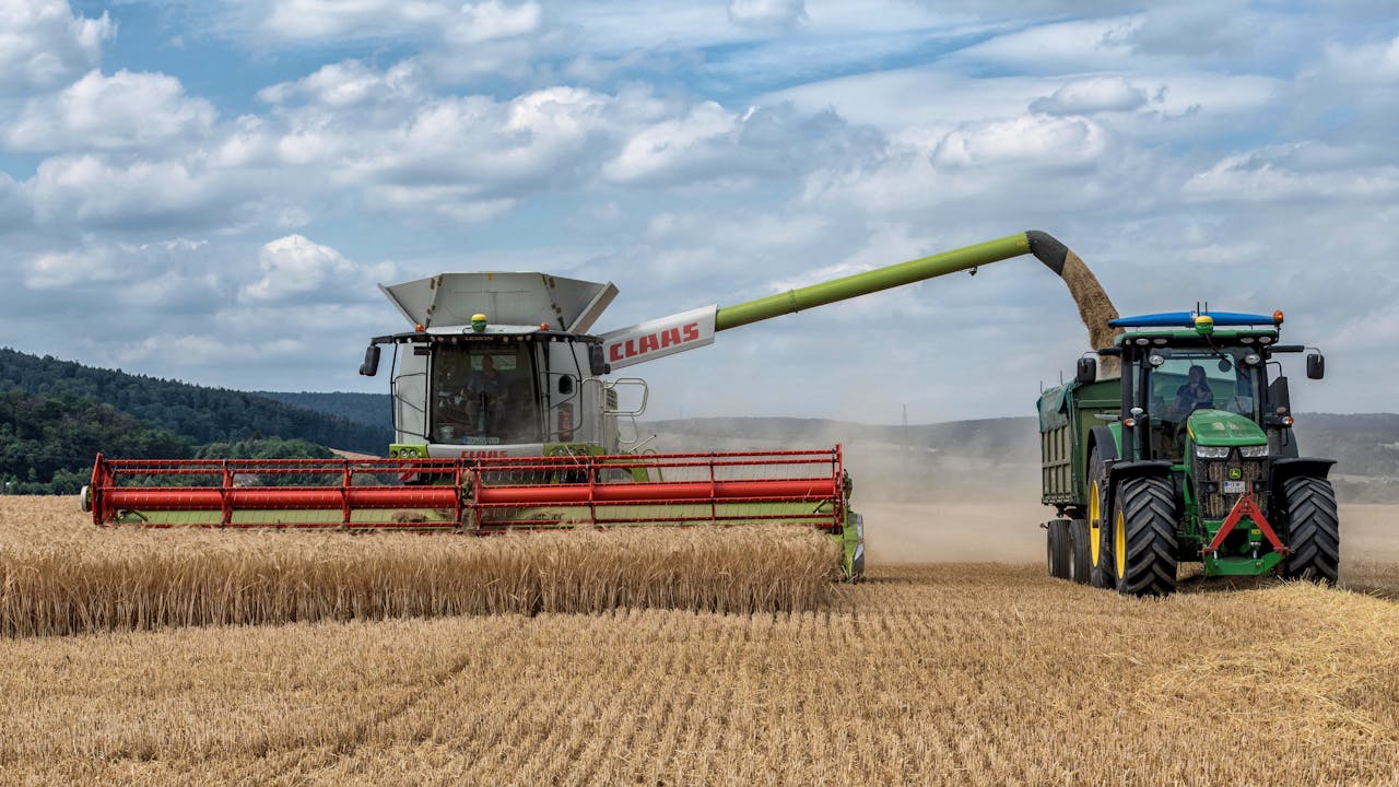 The Art of Drawing Readers In: Your attractive post title goes here Tractors and combine harvester working together during wheat harvest in Höxter, Germany.